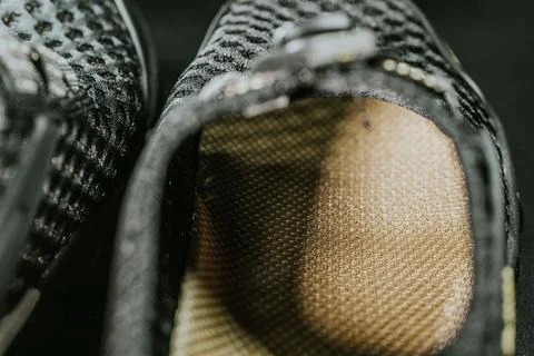 A macro shot of the inside of a black mesh shoe, highlighting the textured. Stock Photos