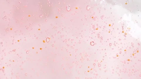 Macro shot of intensive bubbles in peach fuzz color inside it shower gel. Stock Footage 275050451