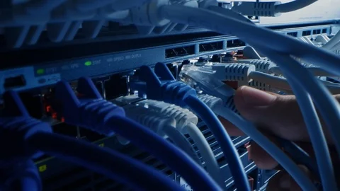 Macro Shot: IT Administrator Plugs in Internet Connector into LAN Router Switch Stock Footage 120927685