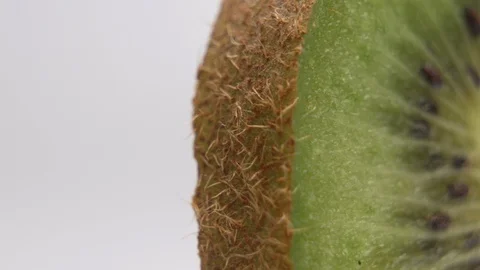 Macro shot of kiwi fruit. Freshly cut organic kiwi on white background Stock Footage 126584467