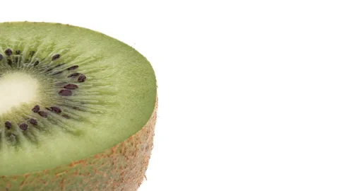 Macro shot of kiwi fruit rotating on white background. Isolated. Vídeo Stock 158541510