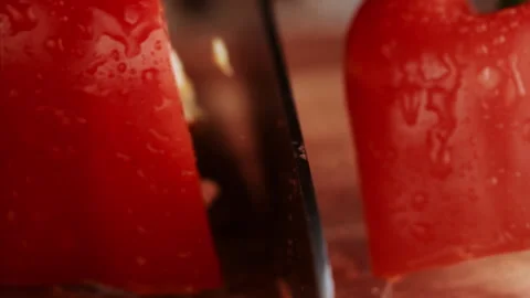 Macro shot of knife cutting red bell pepper in slow motion Stock Footage 152902740