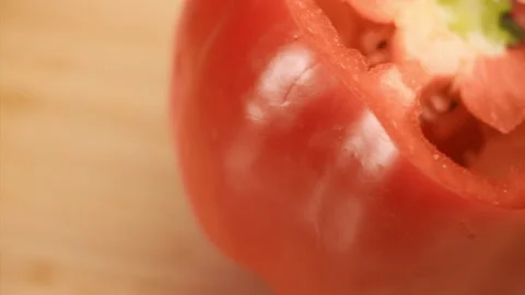 Macro shot of knife cutting red bell pepper in slow motion Stock Footage 152904340
