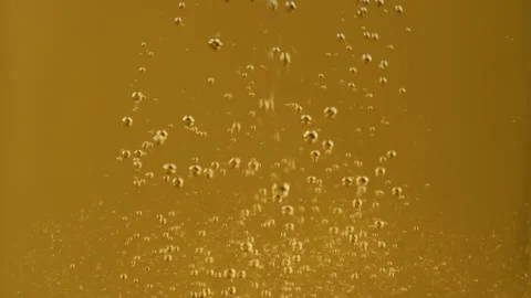 Macro shot of lager beer pouring. Beautiful Beer Bubbles Rising Up Stock Footage 309866515