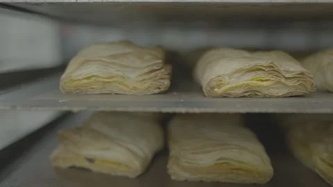 Macro shot of layers in puff pastry dough inside commercial oven Stock-Footage 327353156