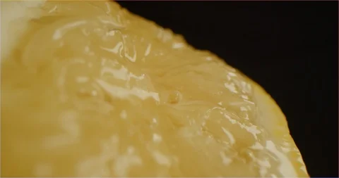 Macro shot of lemon squeezing Stock Footage 126300854