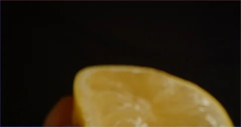 Macro shot of lemon squeezing Stock Footage 126300860