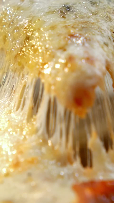 Macro shot of lifting a pepperoni pizza slice with stretching melted cheese.. Stock Footage 337404341