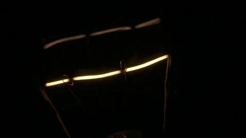 Macro shot of light bulb filament turning on. Stock Footage 72607536