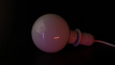 Macro shot of a light lamp flashing on a dark background. The concept of Stock Footage 160110868