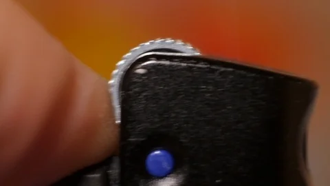 Macro shot of a lighter ignition on a colored background Stock Footage 120069962