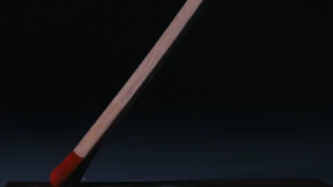 Macro shot of lighting a match. Stock Footage 100550171