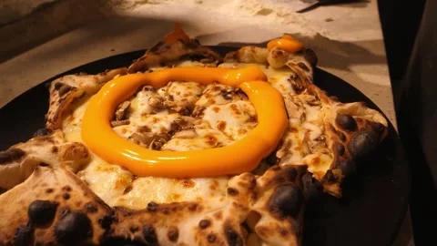 Macro shot of liquid cheddar cheese sauce drizzling over a freshly baked gourmet Stock Footage 337678914