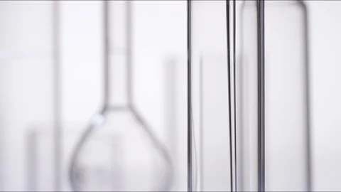 Macro shot of liquid flowing into test tube Stock Footage 100558226