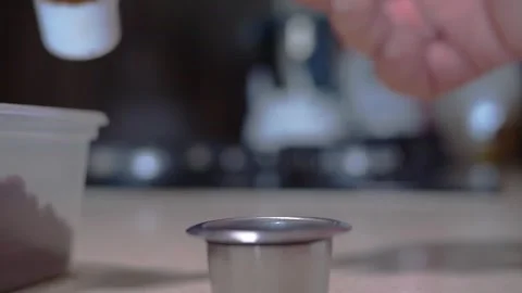 Macro shot of loading coffee powder in Reusable inox capsule in Slow motion Stock Footage 240380793