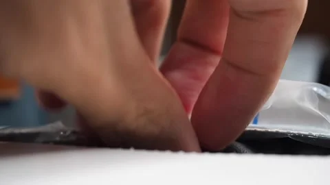 Macro shot male hand pulling two black latex glove from white box. Hygiene Stock Footage 279305413