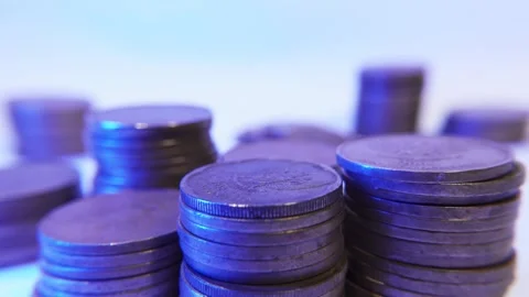 Macro shot of a man hand's adds gold coins to a stack Stock Footage 287741576