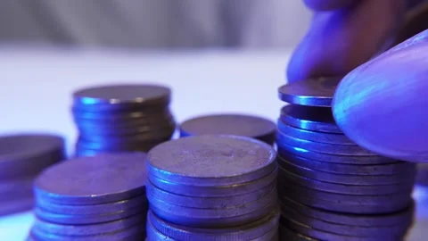 Macro shot of a man hand's adds old coins to a stack Video stock 287742421