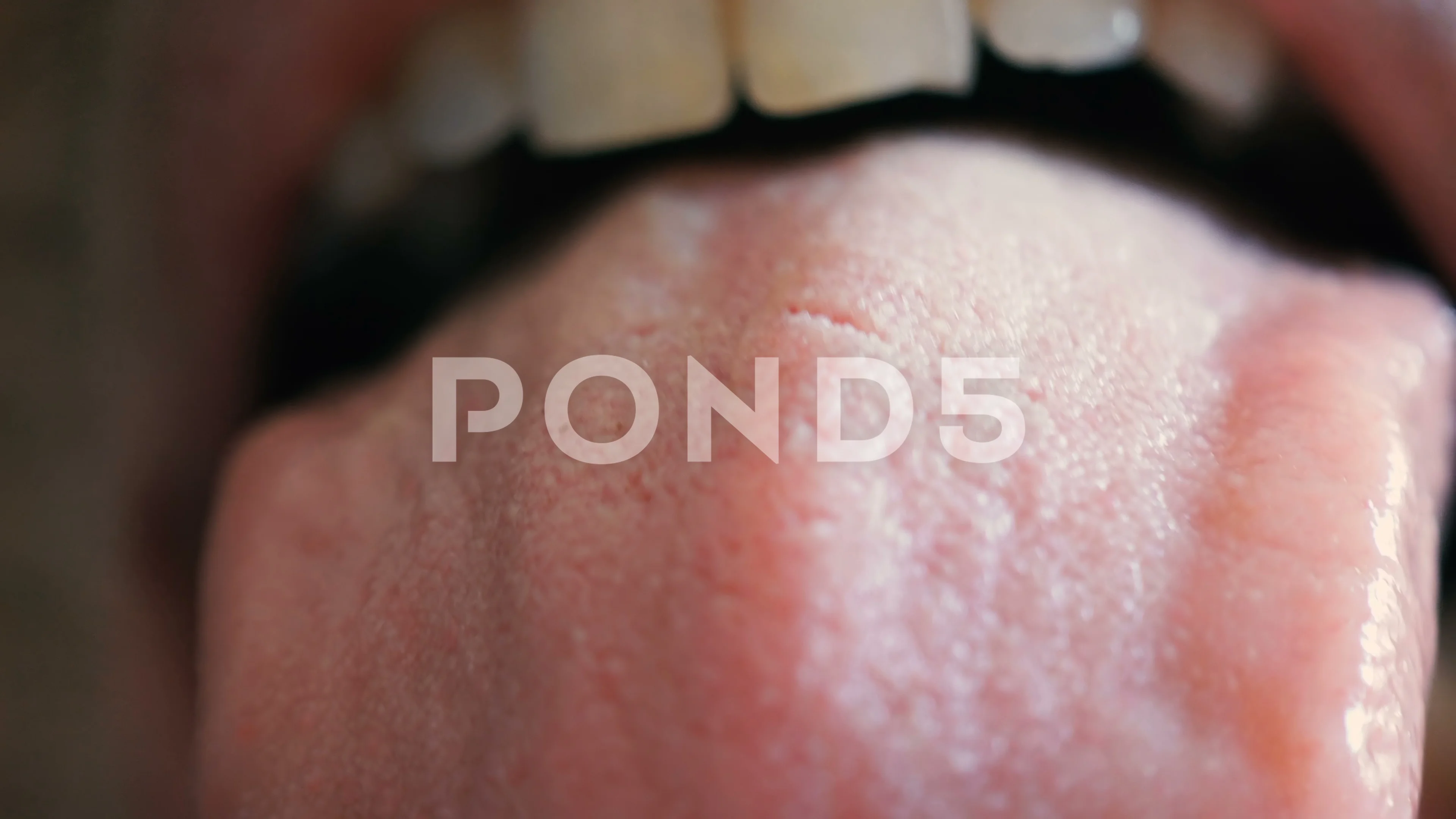 Macro shot of a man sticking out his tongue