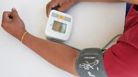 Macro shot of a man using digital blood pressure machine Stock Footage 147700062