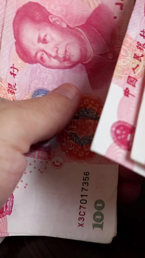 Macro shot of man's hands and Chinese Yuan (CNY) banknotes. Stock Footage 304496591
