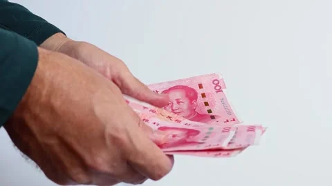 Macro shot of man's hands and Chinese Yuan (CNY) banknotes. Stock Footage 305872086