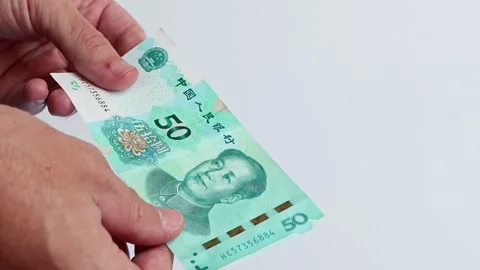 Macro shot of man's hands and Chinese Yuan (CNY) banknotes. Stock Footage 305875844