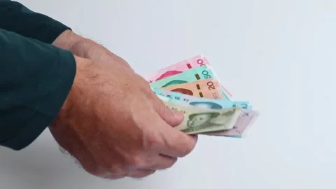 Macro shot of man's hands and Chinese Yuan (CNY) banknotes. Stock Footage 305876972