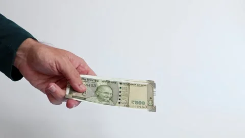 Macro shot of man's hands and Indian rupee (INR) banknotes. Stock Footage 306109699