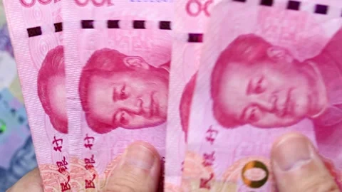Macro shot of mans hands and Chinese Yuan (CNY) banknotes. Stock Footage 309862430