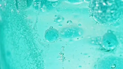 Macro shot of many big and small blue bubbles in water moving around Video stock 124671118