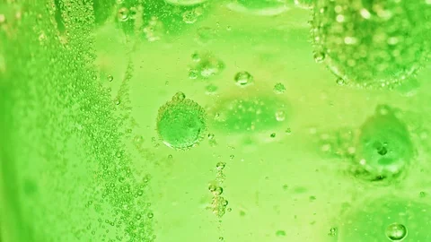 Macro shot of many big and small green bubbles in water moving around Video stock 124671160