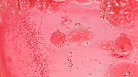Macro shot of many big and small red bubbles in water moving around Video stock 124671187