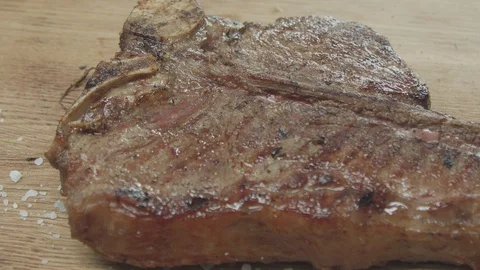 Macro shot of a medium rare steak 스톡 동영상 128830574