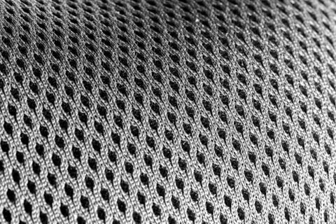 Macro shot of a mesh-like undulating gray silver surface Stock Photos