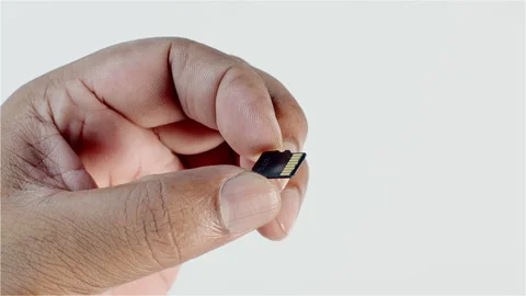 Macro shot of a Micro Sd Card In Hand Stock Footage 248751967