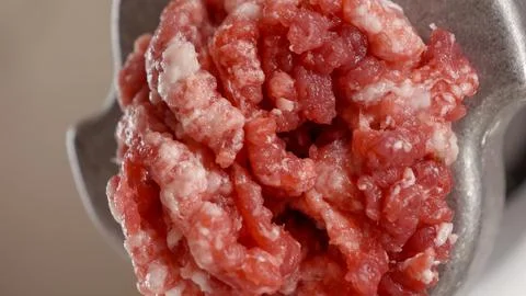 Macro shot of mincing meat in grinder. Cooking at home, kitchen appliance, .. Stock Photos