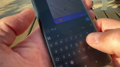 Macro shot of mobile phone screen with active chat conversation inside. Use.. 動画素材 343258642