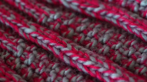 Macro shot with movement of grey and red knitted fabric, extreme close up of Stock Footage 244688085
