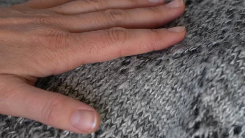 Macro shot with movement of grey knitted fabric, extreme close up of cloth Stock Footage 244134764