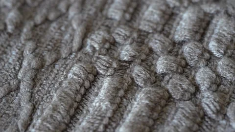 Macro shot with movement of grey knitted fabric, extreme close up of cloth Stock Footage 244487372