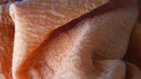 Macro shot with movement of orange fabric, extreme close up of cloth texture Stock Footage 243905513