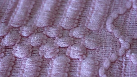 Macro shot with movement of pink knitted fabric, extreme close up of cloth Stock Footage 244488676