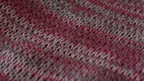Macro shot with movement of red knitted fabric, extreme close up of cloth Stock Footage 244135136
