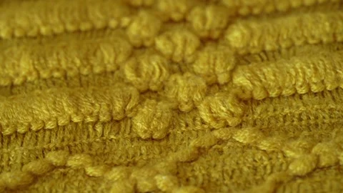 Macro shot with movement of yellow knitted fabric, extreme close up of cloth Stock Footage 244488714
