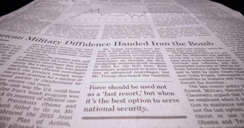 Macro shot moving in through article on war in Ukraine and inflation Stock Footage 179551647