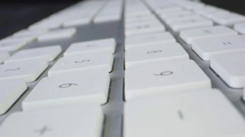 Macro shot moving through a white computer keyboard Stock Footage 130596091
