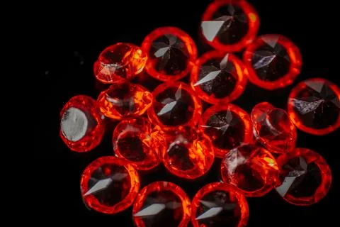 Macro shot of multiple bright red faceted gemstones. Stock Photos