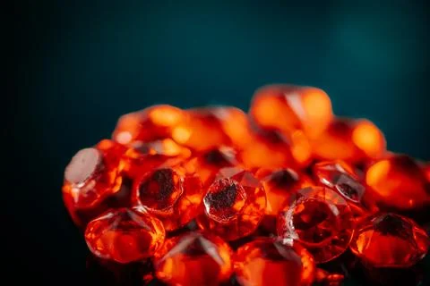 Macro shot of multiple bright red faceted gemstones. Stock Photos
