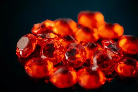 Macro shot of multiple bright red faceted gemstones. Stock Photos